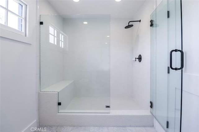 bathroom featuring a shower with shower door