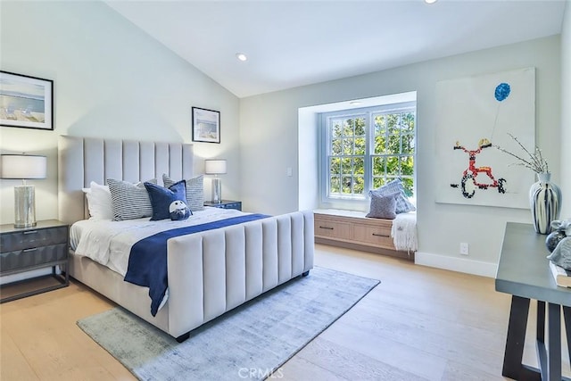 bedroom with lofted ceiling and light hardwood / wood-style flooring