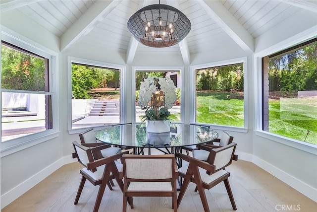 sunroom / solarium with an inviting chandelier and vaulted ceiling with beams