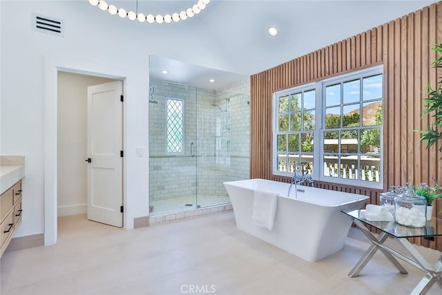 bathroom featuring vanity and shower with separate bathtub