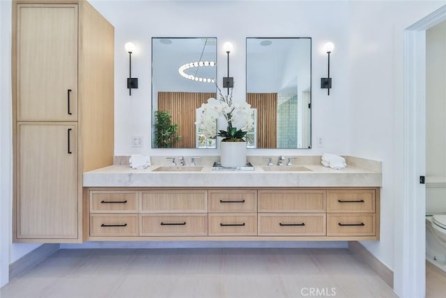 bathroom featuring toilet, tile patterned flooring, and vanity