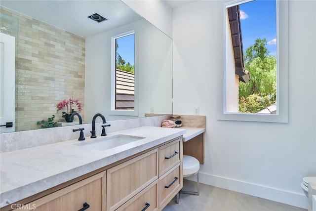 bathroom featuring a healthy amount of sunlight and vanity