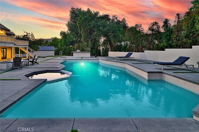 pool at dusk with a patio