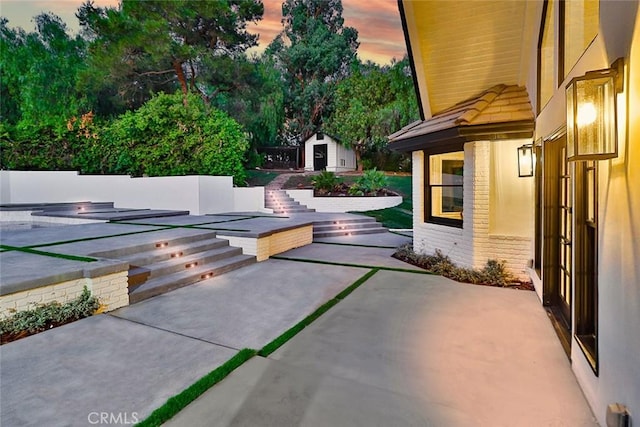 patio terrace at dusk with a storage unit