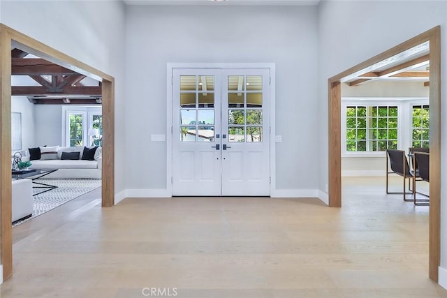 foyer entrance featuring french doors and light hardwood / wood-style flooring