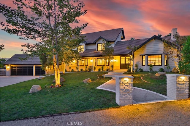 view of front of house with a garage and a lawn