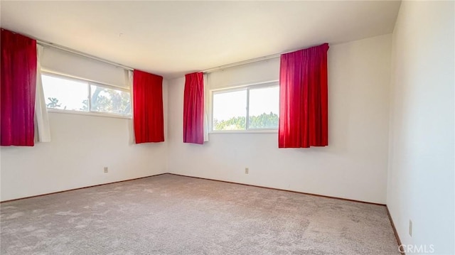 carpeted empty room featuring a healthy amount of sunlight