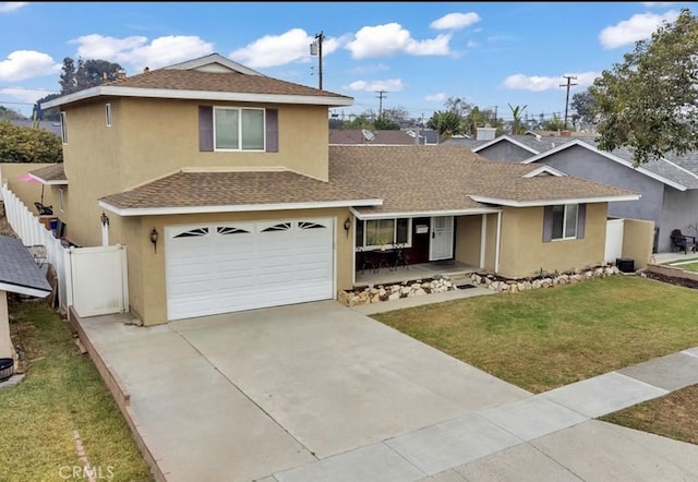 view of front of house with a garage and a front lawn