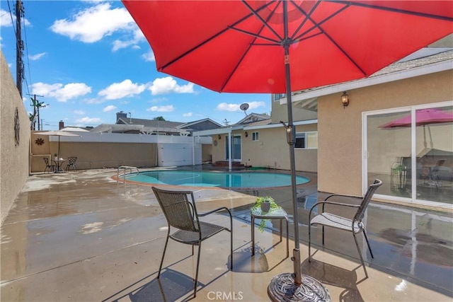 view of pool featuring a patio, fence, and a fenced in pool