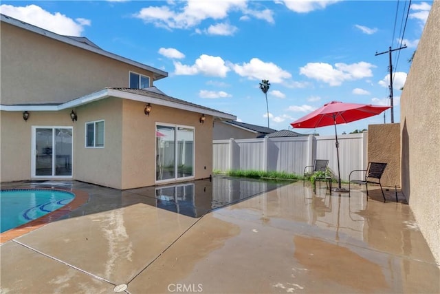 view of swimming pool featuring a fenced in pool, a fenced backyard, and a patio