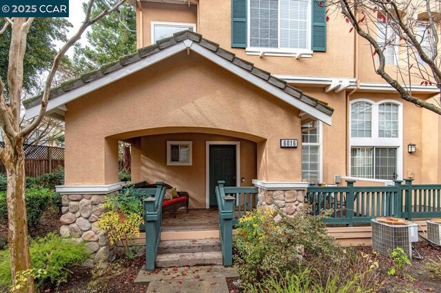 doorway to property featuring cooling unit