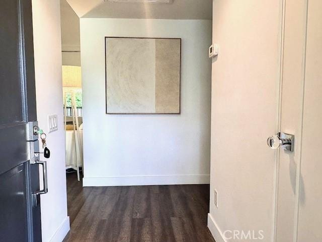 hallway with dark wood-type flooring