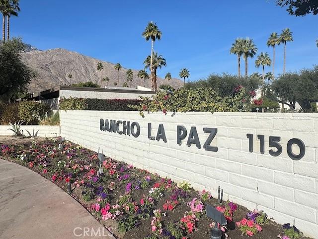 community / neighborhood sign with a mountain view