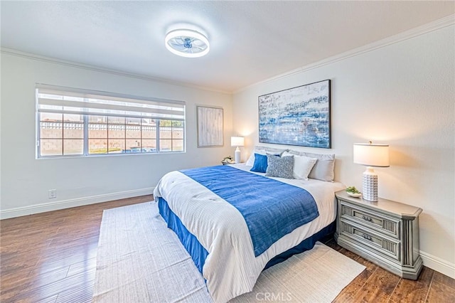 bedroom with dark hardwood / wood-style floors and ornamental molding