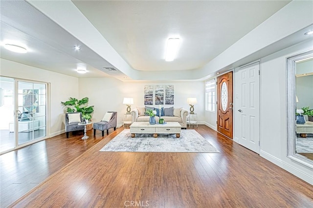 living room with a wealth of natural light and hardwood / wood-style flooring