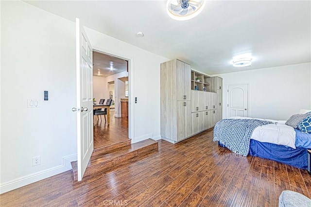 bedroom with dark hardwood / wood-style floors