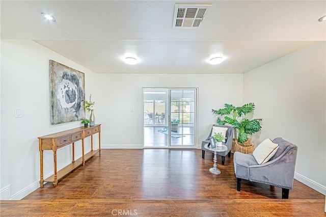 sitting room featuring dark wood-type flooring