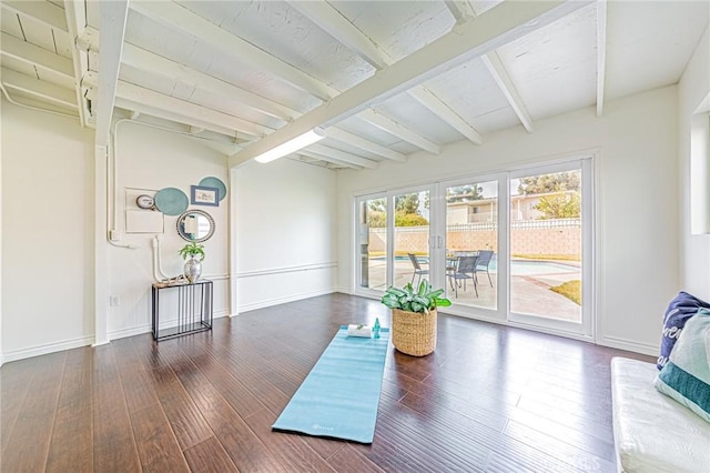 sunroom featuring beam ceiling and french doors