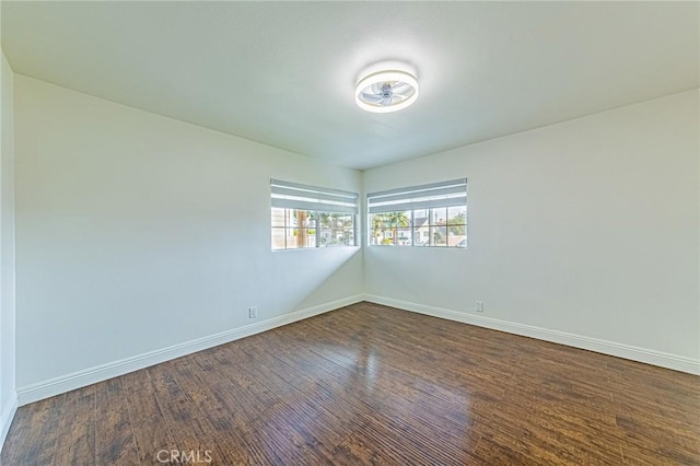 spare room featuring dark wood-type flooring