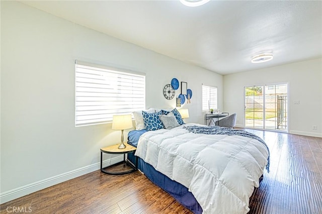 bedroom featuring hardwood / wood-style floors and access to outside