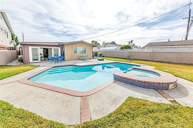 view of pool with a patio area, a yard, and an in ground hot tub