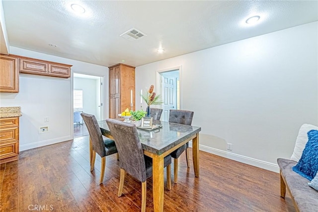 dining area featuring dark hardwood / wood-style floors