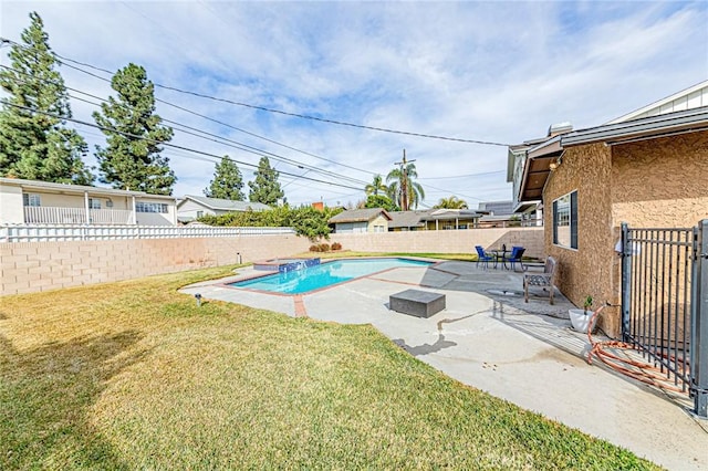 view of swimming pool featuring a patio area and a yard