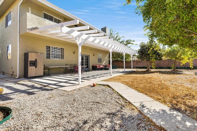 back of property featuring a patio and a pergola