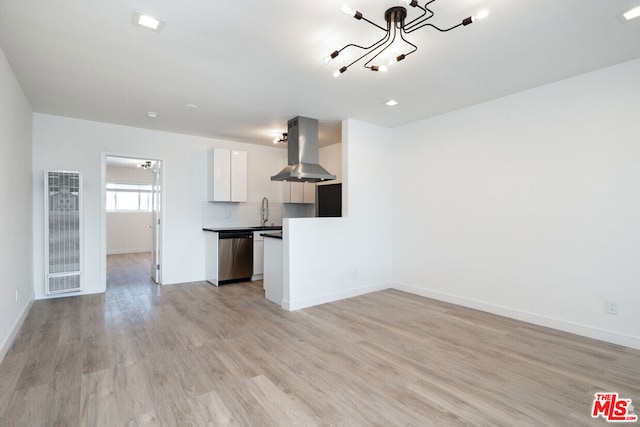 unfurnished living room with a chandelier, light hardwood / wood-style flooring, and sink