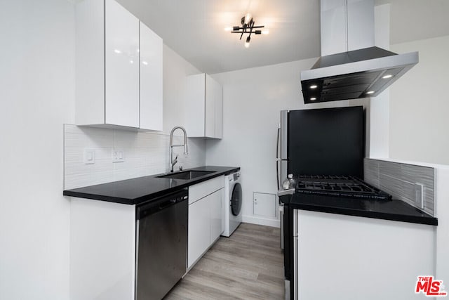 kitchen with white cabinets, appliances with stainless steel finishes, washer / clothes dryer, sink, and island range hood