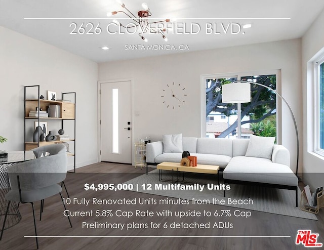 living room featuring a notable chandelier and hardwood / wood-style floors