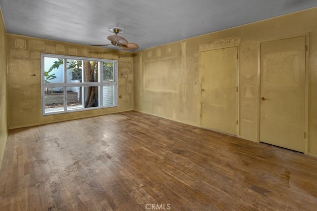 empty room featuring ceiling fan and wood-type flooring