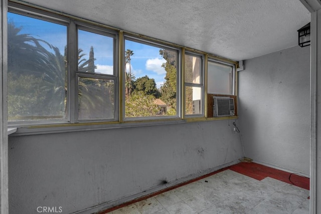 unfurnished room with a textured ceiling and cooling unit