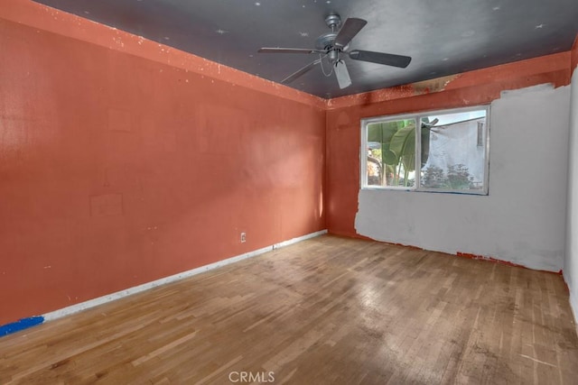 empty room with ceiling fan and wood-type flooring