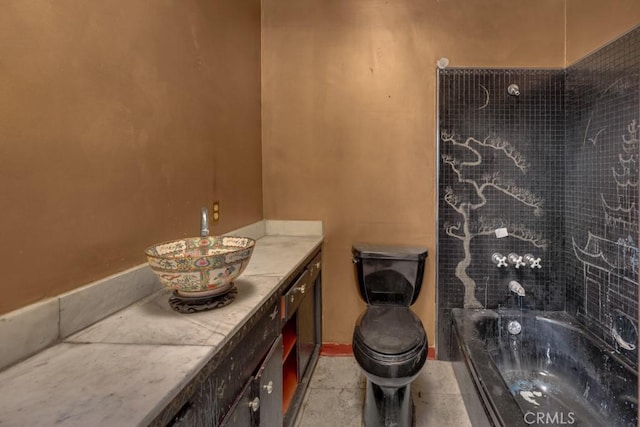 bathroom featuring a washtub, toilet, and vanity