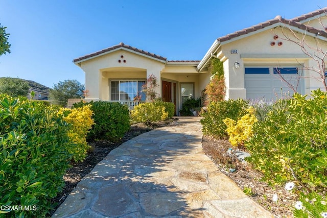 mediterranean / spanish home with a garage