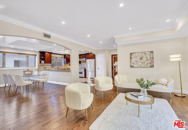 living room featuring crown molding and wood-type flooring