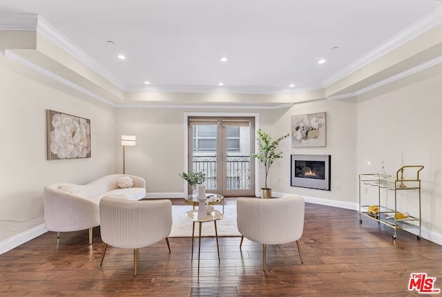 living room with dark wood-type flooring, ornamental molding, and french doors