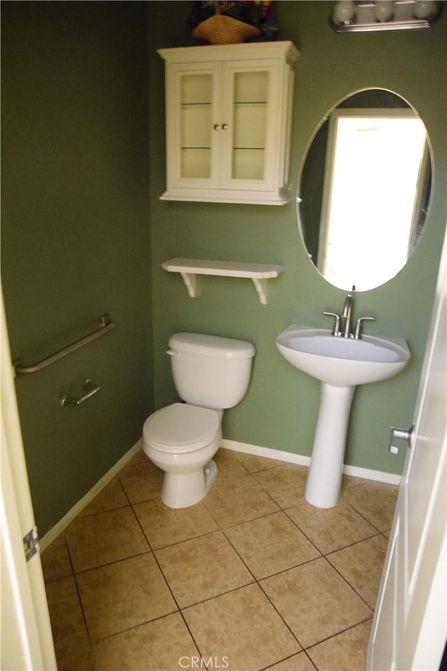 bathroom featuring sink, tile patterned flooring, and toilet