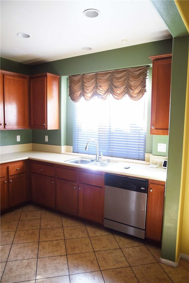 kitchen featuring stainless steel dishwasher, tile patterned floors, a wealth of natural light, and sink