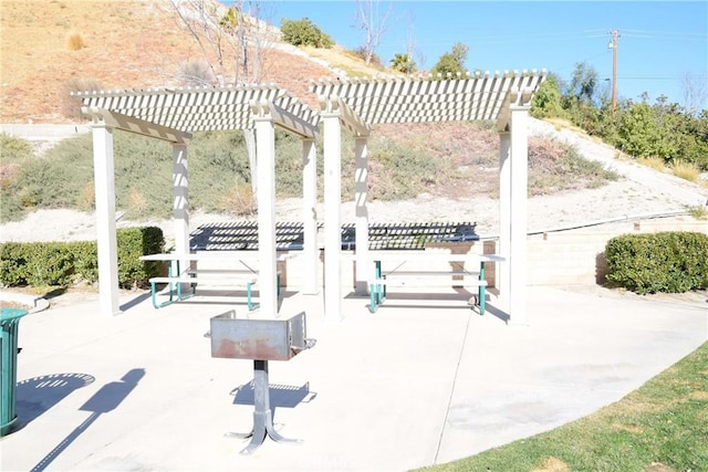 view of community with a patio area and a pergola