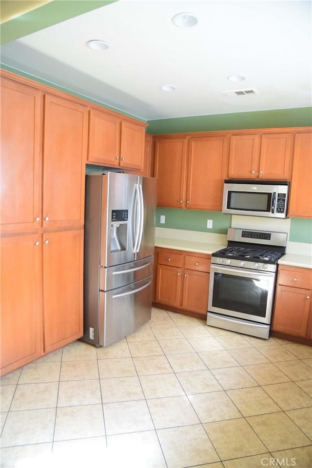 kitchen featuring appliances with stainless steel finishes and light tile patterned floors