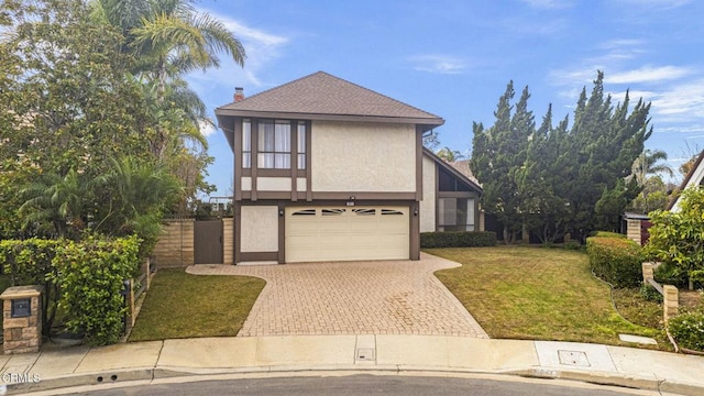 english style home with a garage and a front yard