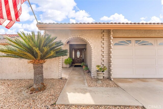 view of exterior entry featuring a garage