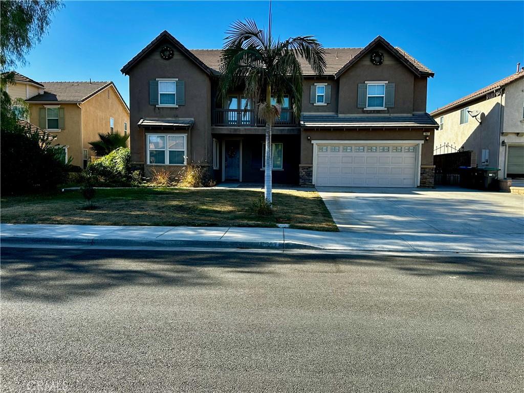 view of front of home featuring a garage and a front lawn