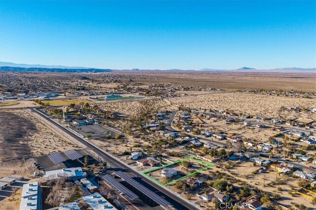 birds eye view of property featuring a mountain view