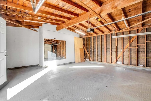 garage with a garage door opener and wooden ceiling