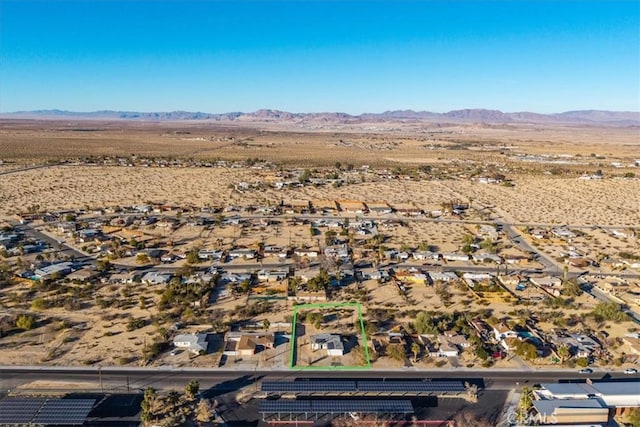 drone / aerial view featuring a desert view and a mountain view