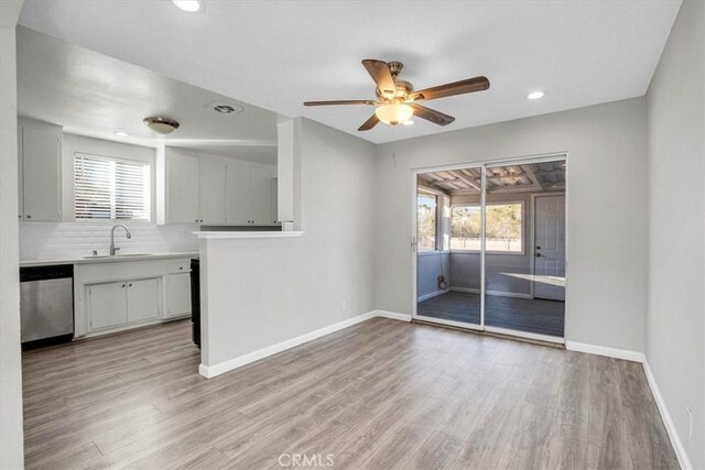 interior space with light wood-type flooring, ceiling fan, plenty of natural light, and sink