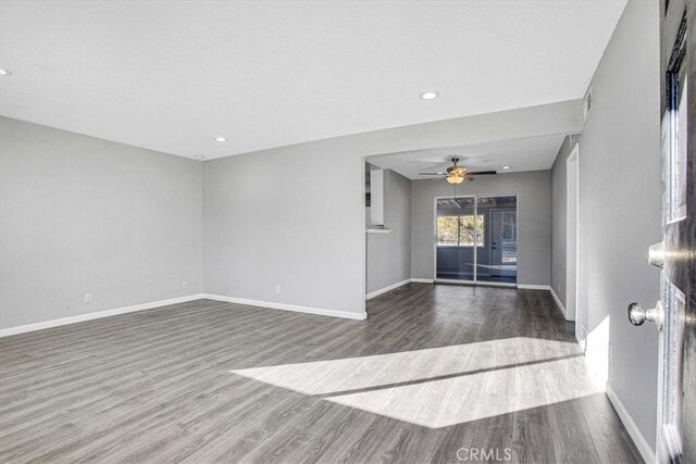 unfurnished living room with ceiling fan and hardwood / wood-style flooring